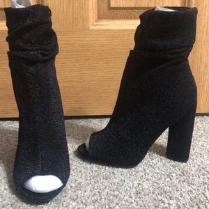 Black stretch opened toe zip up boots